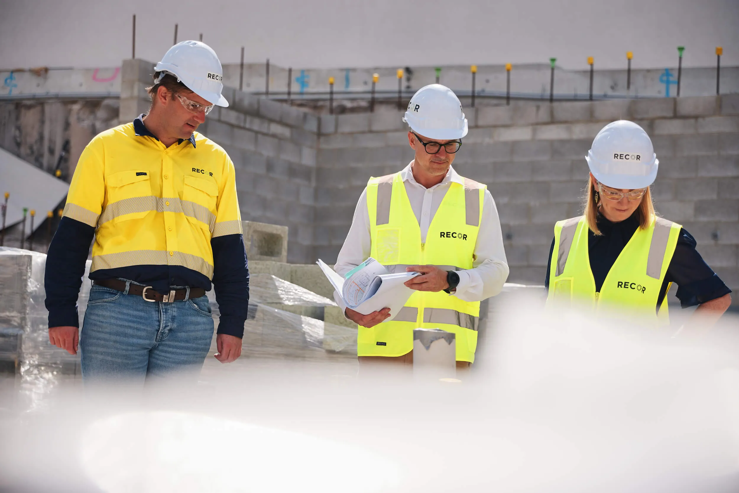 three workers at a construction site